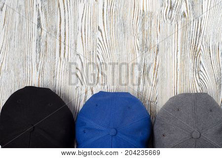 Snapback hats on white wooden background isolation
