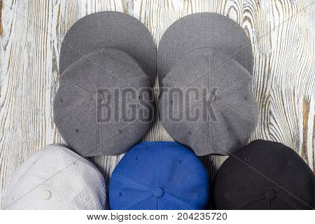 Snapback hats on white wooden background isolation