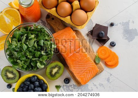 Healthy food good for eyes over white table. Productis fos excellent vision. Space for text