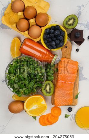 Healthy food good for eyes over white table. Productis fos excellent vision. Space for text