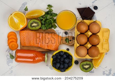 Healthy food good for eyes over white table. Productis fos excellent vision. Space for text
