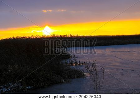Beautiful sunset over the river on winter