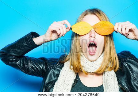 Woman With Autumn Leaves As Glasses In Leather Jacket.