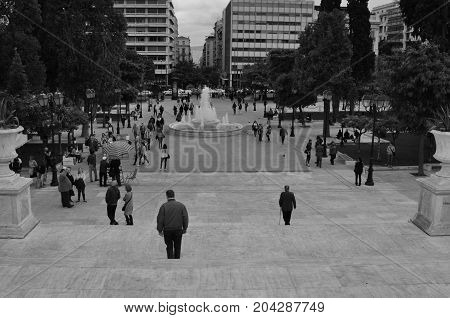 ATHENS GREECE - MAY 6 2014: People at Syntagma public square in downtown Athens Greece. Black and white.