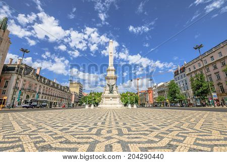 Lisbon, Portugal - August 26, 2017: a popular Obelisk in Praca dos Restauradores or Restoration Square in honor of Portuguese Independence from Spain in Lisbon downtown. Sunny day, blue sky.