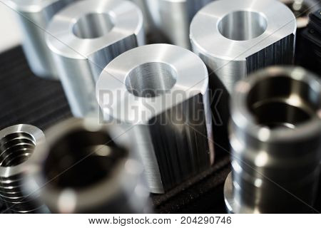 Close-up of a set of metallic gears and parts produced in metal factory