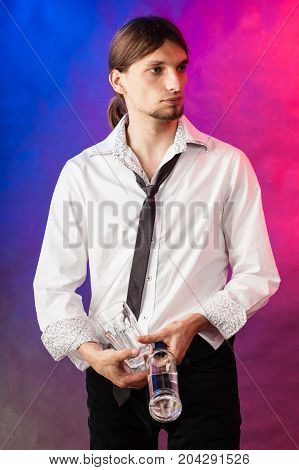 Alcohol liquor party relax flair bartending concept. Barman with bottle and glasses. Youthful tapster on colorful background.