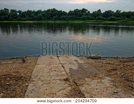 road of concrete slabs suitable to the river, Russia