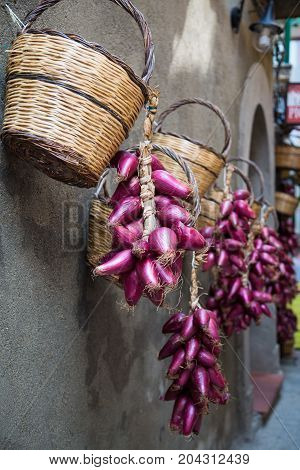 blue onions hanging on the house in the old town of Tropea