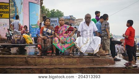 Indian People Sitting On Ganges Riverbank