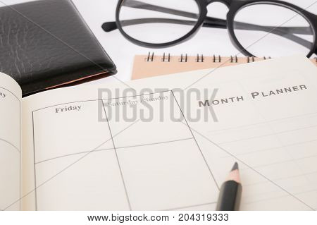 blank planning notebook and pen on desk use us organizer schedule life or business planner concept.