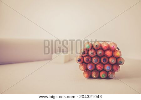 bunch of colored pencil on table retor tone effect.