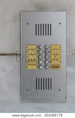Residential building doorbell with buttons and blank name plates. Door bell buzzer background.