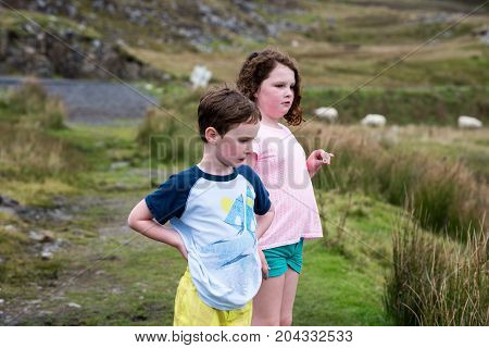 View of Boy and girl walking up the Slieve League Cliffs, County Donegal, Ireland