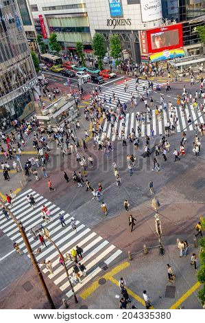 TOKYO, JAPAN JUNE 28 - 2017: Top view of crowd of people crossing in Shibuya street, one of the busiest crosswalks in the world, in the Ginza District in Tokyo, Japan.