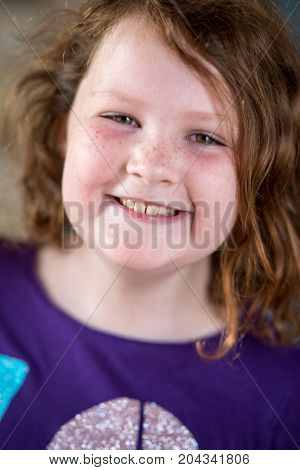 View of Young little girl portrait looking and smiling at the camera.