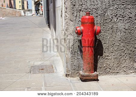 Old red fire hydrant in the street. Fire hidrant for emergency fire access .