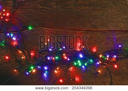 Christmas rustic background - vintage planked wood with lights and free text space.