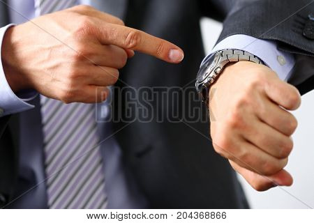 Man In Suit And Tie Check Out Time At Silver Wristwatch