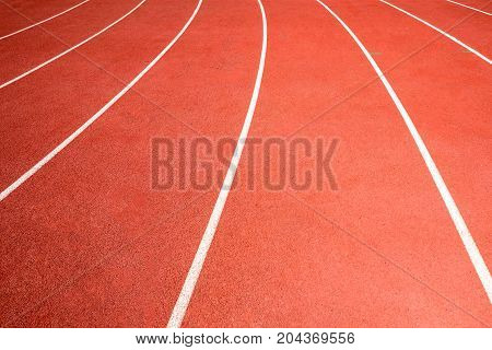red running track line on athletic stadium