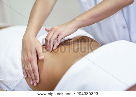 Woman Receiving A Belly Massage At Spa Salon