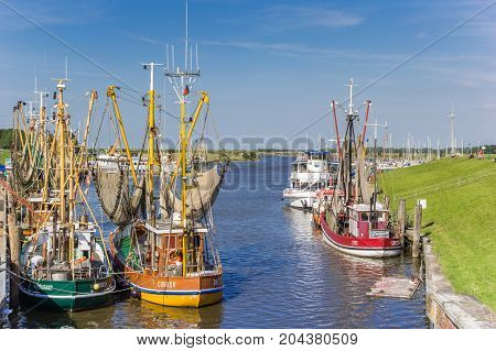 GREETSIEL, GERMANY - JULY 18, 2017: Colorful wooden fishing boats in the harbor of Greetsiel, Germany