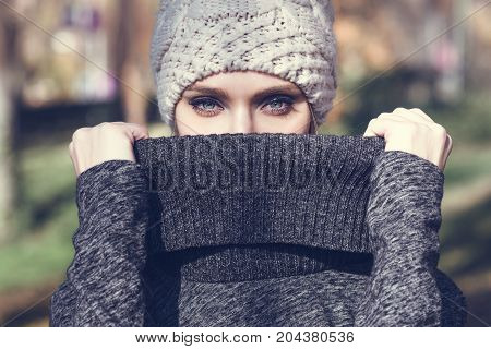 Young Blonde Woman Standing In A Park With Autumn Colors