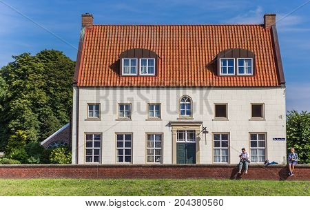GREETSIEL, GERMANY - JULY 18, 2017: Old house and tourists in the historic center of Greetsiel, Germany
