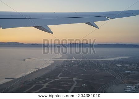 Sunset View Of Sky From A Window Seat In An Airplane