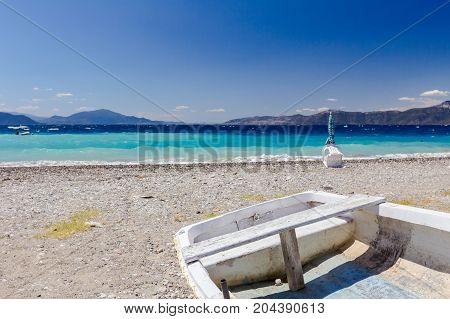 Small boat is dry docked withdrawn at the beach coastline.