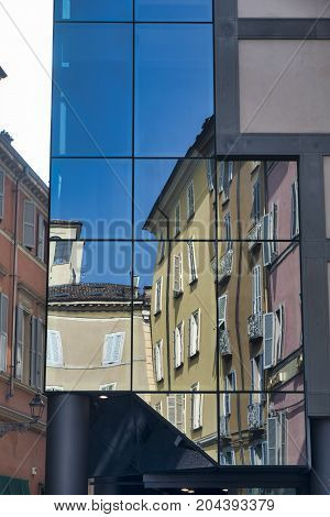 Parma (Emilia Romagna Italy): old and modern buildings in the Cesare Battisti square. Reflections.
