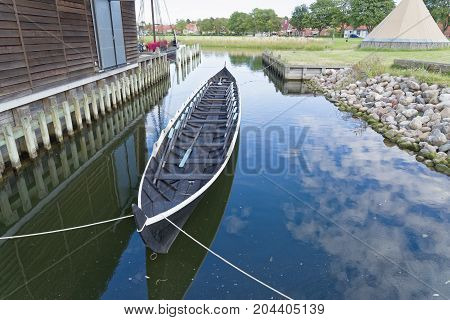 Roskilde Denmark - August 01 2015: replica of ancient boat and visitors outside the Vicking Ship Museum