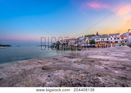 Sunset colorful view at coastal town Primosten in Croatia, marble tourist place on Adriatic Sea.