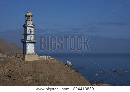 Historic wooden clock tower from the era of nitrate mining in the Atacama Desert, in the coastal town of Pisagua in the Tarapaca Region of northern Chile.