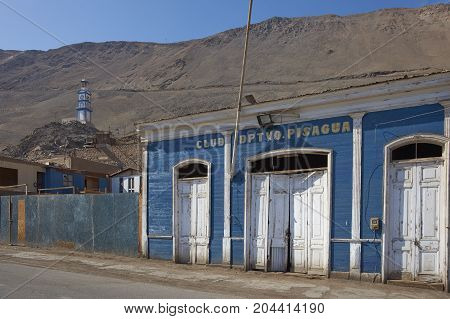 Pisagua, Tarapaca Region, Chile - August 21, 2017: Historic wooden buildings from the era of nitrate mining in the Atacama Desert, in the coastal town of Pisagua in northern Chile.