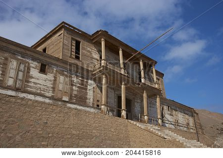 Historic wooden building from the era of nitrate mining in the Atacama Desert, in the coastal town of Pisagua in the Tarapaca Region of northern Chile.
