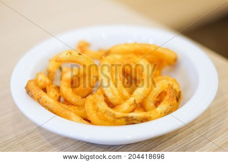 Hot french fries serve on white plate for food background or texture - Fast Food concept.