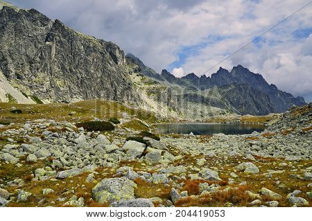 High Tatras in Slovakia. Monumental peaks. Summer scenic landscape mountain view. Alpine trail. Prostredny hrot and Starolesnianske tarn in Big cold valley.