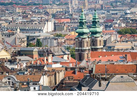 View over the rooftops of Budapest in Hungary with the towers of the University Church rise above the rest.