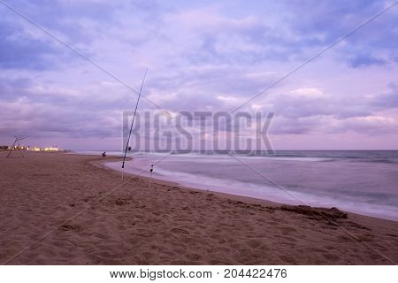 Sunset over Castelldefels beach in summer with clouds