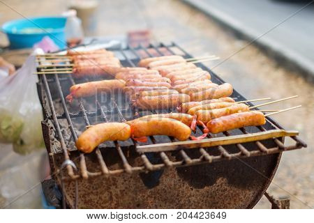 The East Sausages grill on hot wire rack Thailand.