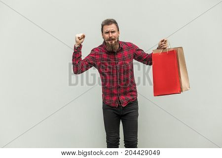 Happiness Businessman Holding Paper Bags On Hands And Looking At Camera.