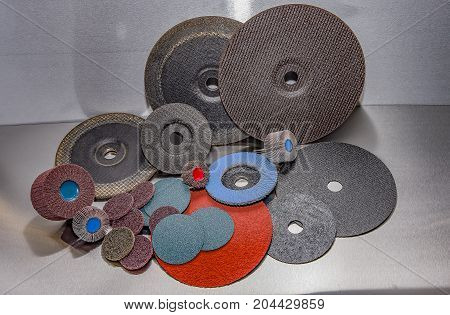 A pile of color abrasive sandpaper for metal working sandpaper for metal working