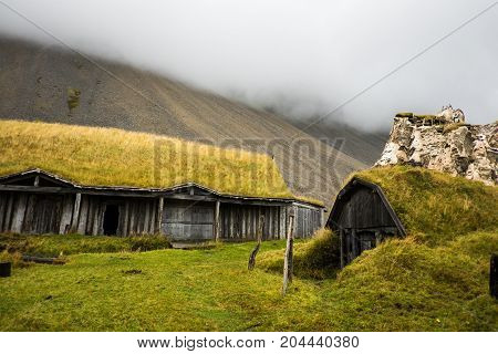 Traditional icelandic viking skyfall village. Wooden houses near mountains. Skyfall.