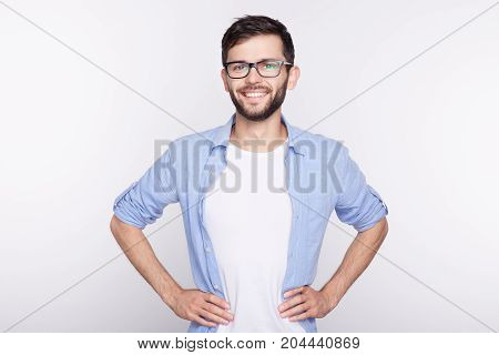 Stylish bearded man with appealing blue eyes smiling into camera having pleased expression being glad to meet his girlfriend. Hipster guy with beard grinning having cheerful look. Positive emotions.