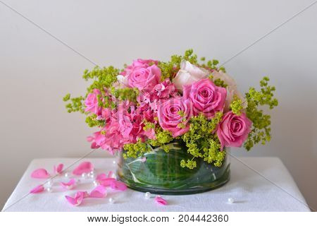 Close-up floral composition with a pink roses .Many beautiful fresh pink roses on a table.