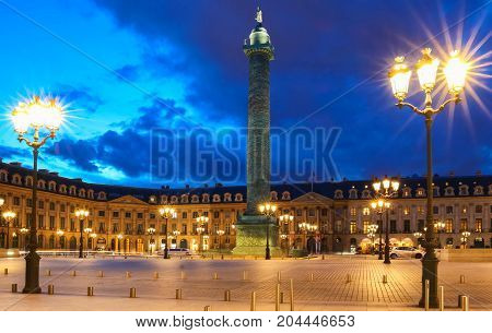 Vendome column with statue of Napoleon Bonaparte, on the Place Vendome at night, in France. Vendome column has 425 spiraling bas-relief bronze plates were made out of cannon.