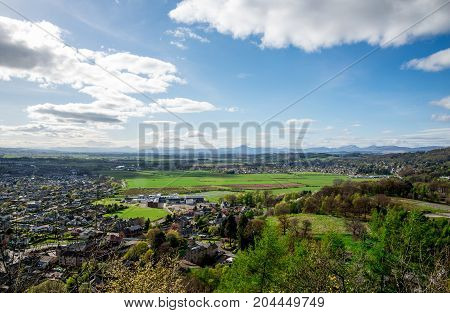 A scenic view of Stirling city suburbs and countryside from the Wallace Monument in Scotland