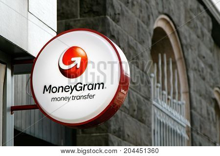 Reykjavik Iceland August 22 2017: MoneyGram sign is mounted to a wall above the entrance to their branch.
