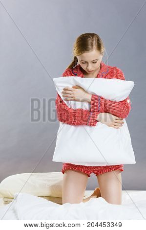 Sad Depressed Girl In Bed Gripping Pillow